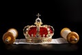 A Gold Coronation Crown with Red Velevet on a Bible on an Open Hebrew Scroll Royalty Free Stock Photo