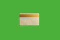 Gold credit card isolated on the green background Royalty Free Stock Photo