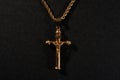 Gold cross on a chain on a black background Royalty Free Stock Photo