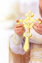 Gold cross in the hands of a priest close-up. Time to consecrate the water