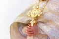 Gold cross in the hands of a priest close-up. Time to consecrate the water