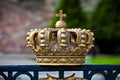 Gold crown decorative element on the fence