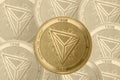Gold crypto coin tron trx sign, against the background of tron tanned coins
