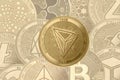 Gold crypto coin tron trx sign, on the background of shaded coins ethereum, iota, zcash, 0x, stellar, ripple, neo, litecoin, eos