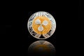 Gold cryptocurrency coin - Ripple coin, isolated on a black background