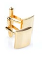 Gold cuff links on white background