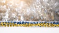 Gold and Dark Blue Beads with Silver Bokeh Lights in Festive Holiday Setting Royalty Free Stock Photo