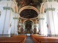 Gold decorated church painted ceiling with benches