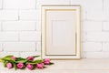 Gold decorated frame mockup with magenta tulips bouquet