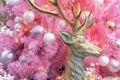 Gold deer on the background of a pink Christmas tree with white and silver balls Royalty Free Stock Photo
