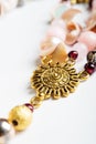 Gold detail of bijouterie with semiprecious at white background