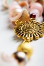 Gold detail of bijouterie with semiprecious at white background