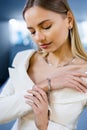 Gold and diamond bracelet adorns the wrist of an elegantly glamorous model girl in a luxury jewelry boutique. The woman Royalty Free Stock Photo