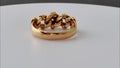 Gold and diamond knot ring rotating on white surface background. 3d render animation of gold and diamond knot ring. Gold and