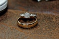 Gold and Diamond Wedding Ring on Leather Surface