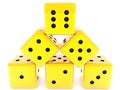 Gold dice are stacked in a pyramid on white Royalty Free Stock Photo