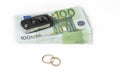 Gold digger concept. Money, car and wedding rings