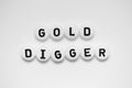 GOLD DIGGER written on white circles isolated on a white background
