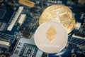 Gold Digital Cryptocurrency Coin Ethereum on Computer Motherboard. Crypto Currency Background.