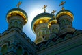 The gold domes with crosses on the roof.