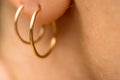 Gold earrings in earlobes. Macro Royalty Free Stock Photo