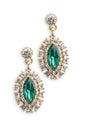 Gold earrings with emerald isolated on white