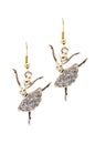 Gold earrings in the form of a ballerina inlaid with gemstones on a white background