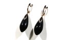 gold earrings with onyx and diamonds on a white background. Long earrings. women's accessories Royalty Free Stock Photo