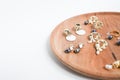 Gold earrings. Women's jewelry. Beautiful golden tones earrings with pearls on a wooden tray. Copy space