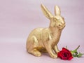 gold Easter bunny rabbit on pink background