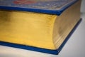 Gold edge of closed old vintage book with blue cover Royalty Free Stock Photo