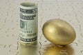 Gold egg and dollar currency on puzzle Royalty Free Stock Photo