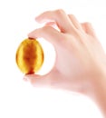 Gold egg in hand isolated Royalty Free Stock Photo