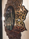Gold embossed calligraphy bearing the name of god in Arabic "Allah"