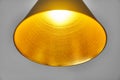 Gold embossed lampshade. Round yellow lamp on grey background