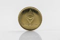 Gold Etherium Token with white background
