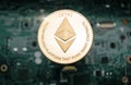 Gold etherum coin, on background of computer motherboard Royalty Free Stock Photo