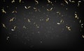 Gold falling confetti and stars isolated on black background. Golden ribbons for birthday celebration, New Year, anniversary Royalty Free Stock Photo
