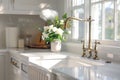 A gold faucet on an apron sink in a white kitchen. Royalty Free Stock Photo