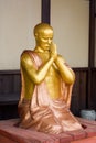 Gold figure of the praying monk