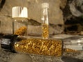 Gold flakes in vials