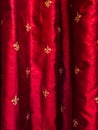 Gold fleur de lis on red silk curtains