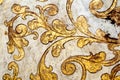 Gold flourish design. White background.