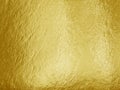 Gold foil background with highlights and uneven texture