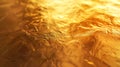 Gold foil background shimmering with light reflections. Royalty Free Stock Photo