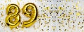 Gold foil balloon number, digit eighty-nine. Birthday greeting card with inscription 89. Anniversary celebration. Banner