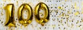 Gold foil balloon number, digit one hundred. Birthday greeting card with inscription 100. Anniversary celebration Royalty Free Stock Photo