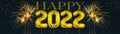 Gold foil balloons numeral 2022 and golden firework on dark blue wooden texture - HAPPY NEW YEAR - Festive silvester New Year`s Royalty Free Stock Photo