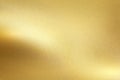 Gold foil metal wall with glowing shiny light, abstract texture background Royalty Free Stock Photo