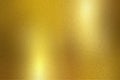 Gold foil metallic wall with glowing shiny light, abstract texture background Royalty Free Stock Photo